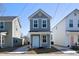 Charming two-story home with gray siding, white trim, and a light blue front door at 2021 Arbutus Ave, North Charleston, SC 29405