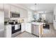 Stylish kitchen open to the living area, stainless steel appliances, and marble countertops at 2021 Arbutus Ave, North Charleston, SC 29405