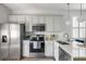 Bright kitchen features stainless steel appliances and white cabinetry at 2021 Arbutus Ave, North Charleston, SC 29405