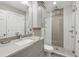 Modern bathroom featuring a tiled shower, marble countertop, and gray vanity at 204 William St, Mount Pleasant, SC 29464