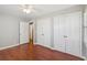 Spacious bedroom with hardwood floors, ceiling fan, and ample closet space at 204 William St, Mount Pleasant, SC 29464