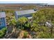 Exterior view of a marsh front home with lots of trees and mature landscaping at 204 William St, Mount Pleasant, SC 29464