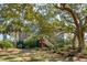 Charming exterior featuring mature oak trees and lush landscaping at 204 William St, Mount Pleasant, SC 29464