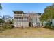 Multi-story home featuring multiple porches, lush backyard, and views at 204 William St, Mount Pleasant, SC 29464