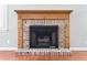 Close-up of a charming brick fireplace with a wooden mantel at 204 William St, Mount Pleasant, SC 29464