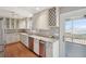 Kitchen offers stainless appliances, stone counters, and access to the screened porch at 204 William St, Mount Pleasant, SC 29464