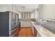 Kitchen features stainless appliances, white cabinets, stone countertops and wood floors at 204 William St, Mount Pleasant, SC 29464