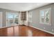 Sun-filled room with built-in shelving, plantation shutters, and balcony access at 204 William St, Mount Pleasant, SC 29464
