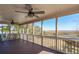 Large screened porch with multiple ceiling fans offers scenic marsh views at 204 William St, Mount Pleasant, SC 29464