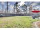 Large backyard featuring green grass, wood fence, and outdoor dining area at 211 Tall Grass Ct, Summerville, SC 29483