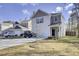 Charming two-story home featuring a manicured lawn, attached garage, and modern architectural details at 211 Tall Grass Ct, Summerville, SC 29483