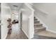 Bright hallway with staircase and view into the living room, showcasing the home's open layout at 211 Tall Grass Ct, Summerville, SC 29483