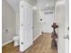 Hallway with a half-bathroom and a view of the front door with natural light and LVP flooring at 211 Tall Grass Ct, Summerville, SC 29483