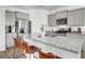 Modern kitchen features gray cabinets, stainless steel appliances, and a spacious island with granite countertops at 211 Tall Grass Ct, Summerville, SC 29483