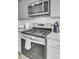 Detailed view of the kitchen stove with stainless steel appliances and granite countertops at 211 Tall Grass Ct, Summerville, SC 29483