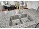 Close-up of a kitchen island featuring a stainless steel sink and granite countertop with a modern faucet at 211 Tall Grass Ct, Summerville, SC 29483