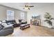 Comfortable living room boasts natural light, wood-look floors, a ceiling fan, and a relaxing atmosphere at 211 Tall Grass Ct, Summerville, SC 29483