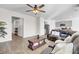 Inviting living room featuring wood-look flooring, a ceiling fan, and an open layout adjacent to the kitchen at 211 Tall Grass Ct, Summerville, SC 29483