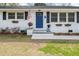 Charming home featuring a blue front door, white brick, an American flag, and flower boxes at 2137 Barbour Dr, Charleston, SC 29414