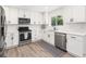 Bright kitchen featuring white cabinets, stainless steel appliances, and light wood flooring at 2137 Barbour Dr, Charleston, SC 29414