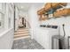 Functional laundry room with storage shelves and a washing machine and dryer set at 2137 Barbour Dr, Charleston, SC 29414