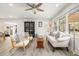 Bright living room with hardwood floors, modern furniture, ceiling fan, and natural light at 2137 Barbour Dr, Charleston, SC 29414