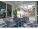 Screened patio with metal table, seating, and ceiling fan for outdoor entertaining at 2137 Barbour Dr, Charleston, SC 29414