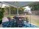 Inviting screened porch featuring a blue rug, ceiling fan, and outdoor furniture at 2137 Barbour Dr, Charleston, SC 29414