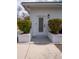 Side door featuring modern design, concrete planters, gravel, and well-maintained landscaping at 2137 Barbour Dr, Charleston, SC 29414