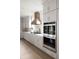 A spacious kitchen with modern appliances, custom cabinetry, and a stylish range hood at 2151 Arthur Rose Ln, Johns Island, SC 29455
