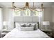 Serene main bedroom with statement chandelier and bedside tables with modern lamps at 2151 Arthur Rose Ln, Johns Island, SC 29455