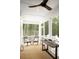 Screened-in porch featuring a ceiling fan and outdoor furniture with a view of the surrounding trees at 2151 Arthur Rose Ln, Johns Island, SC 29455