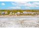 Stunning aerial view of beachfront homes, the sandy beach, and the ocean on a sunny day at 220 W Arctic Ave, Folly Beach, SC 29439