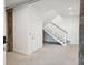 Spacious basement with stairs, a secured door, and concrete floors at 220 W Arctic Ave, Folly Beach, SC 29439