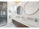 Modern bathroom with double vanity, stone shower, and elegant fixtures at 220 W Arctic Ave, Folly Beach, SC 29439