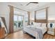 Beautiful bedroom with ceiling fan, natural light and an exterior door to the deck at 220 W Arctic Ave, Folly Beach, SC 29439