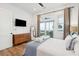 Bright bedroom featuring wood floors, white walls, sliding doors to deck and ocean view at 220 W Arctic Ave, Folly Beach, SC 29439
