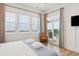 Bright bedroom with an exterior balcony, a large window view, and wooden floors at 220 W Arctic Ave, Folly Beach, SC 29439