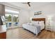 Bright bedroom featuring wood floors, white walls, sliding doors to deck and pool view at 220 W Arctic Ave, Folly Beach, SC 29439