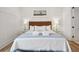 Bright bedroom features wood floors, white walls, and tastefully coordinated decor and furnishings at 220 W Arctic Ave, Folly Beach, SC 29439
