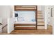 Custom bunk beds with pull-out trundle, built-in ladder, and modern lighting at 220 W Arctic Ave, Folly Beach, SC 29439