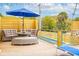 Outdoor deck with a seating area with a dark blue umbrella for shade at 220 W Arctic Ave, Folly Beach, SC 29439