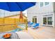 Outdoor deck with grill, lounge chairs, a seating area with a blue umbrella, and string lights at 220 W Arctic Ave, Folly Beach, SC 29439