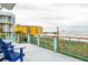 Spacious oceanfront deck with lounge chairs overlooking the beach and a sunny view at 220 W Arctic Ave, Folly Beach, SC 29439