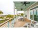 Spacious covered deck featuring ceiling fans, comfortable seating, and breathtaking ocean views at 220 W Arctic Ave, Folly Beach, SC 29439