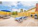 Outdoor deck with chairs, a grill, a fence, and outdoor lights hanging above at 220 W Arctic Ave, Folly Beach, SC 29439