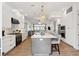 Modern kitchen featuring white cabinetry, stainless steel appliances, and an island with bar seating at 220 W Arctic Ave, Folly Beach, SC 29439