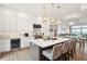 Elegant kitchen with white cabinets, quartz countertops, an island with seating, and ocean views at 220 W Arctic Ave, Folly Beach, SC 29439