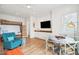 Living room area with bunk beds, TV, seating, and game table at 220 W Arctic Ave, Folly Beach, SC 29439