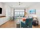 The bright living room has a coastal-themed decor, large windows, and ocean views at 220 W Arctic Ave, Folly Beach, SC 29439